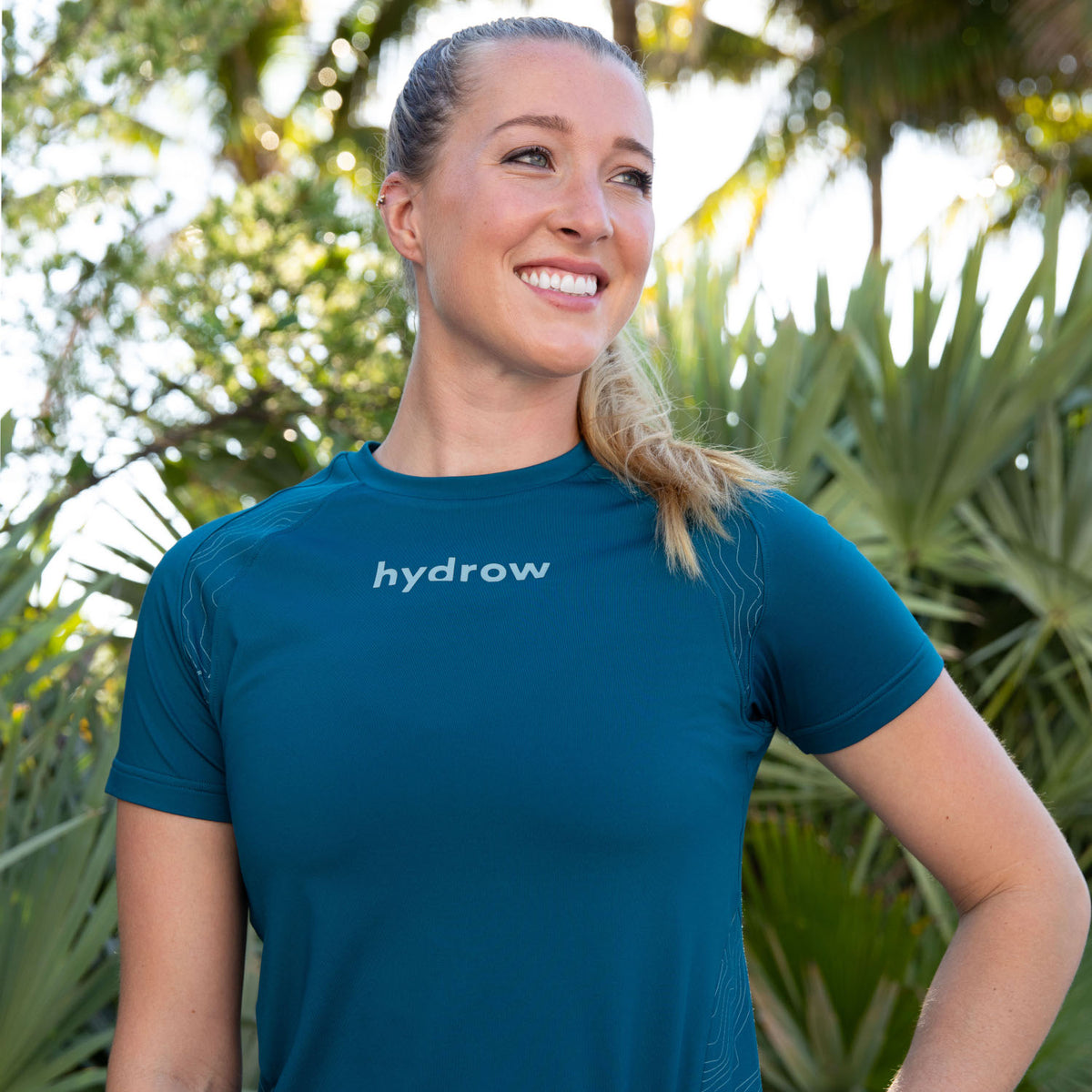 model posing wearing moisture wicking compression tee  in dark blue with hydrow logo on upper cheat