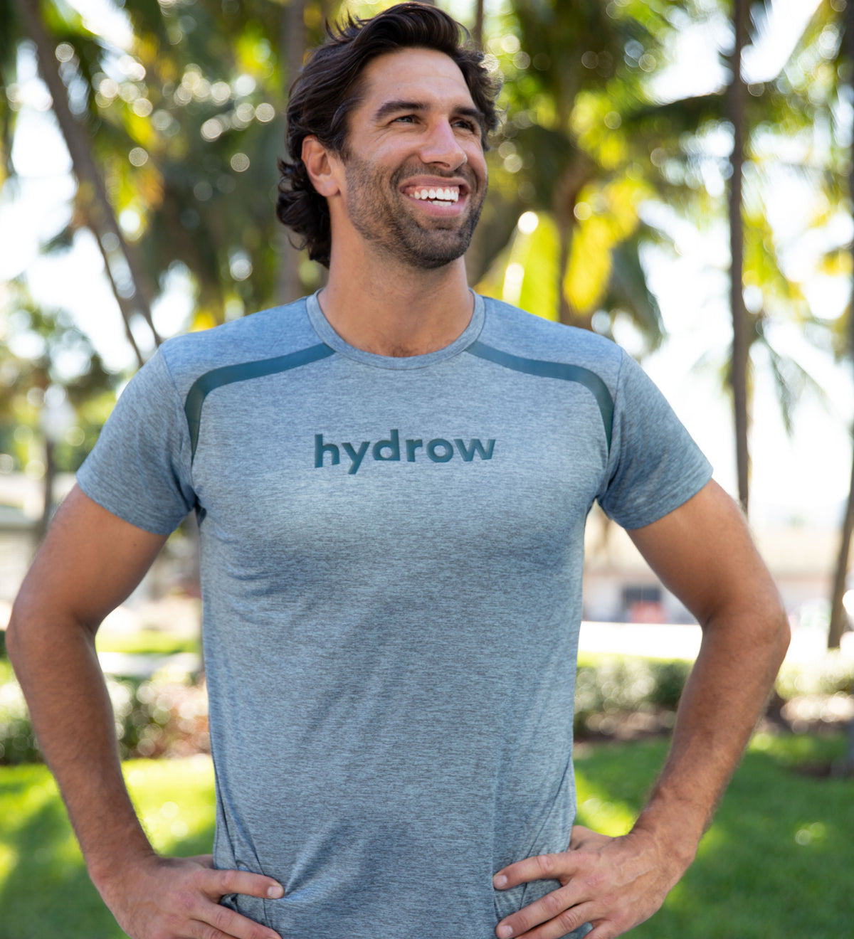 Man posing in grey t-shirt with hydrow logo on chest