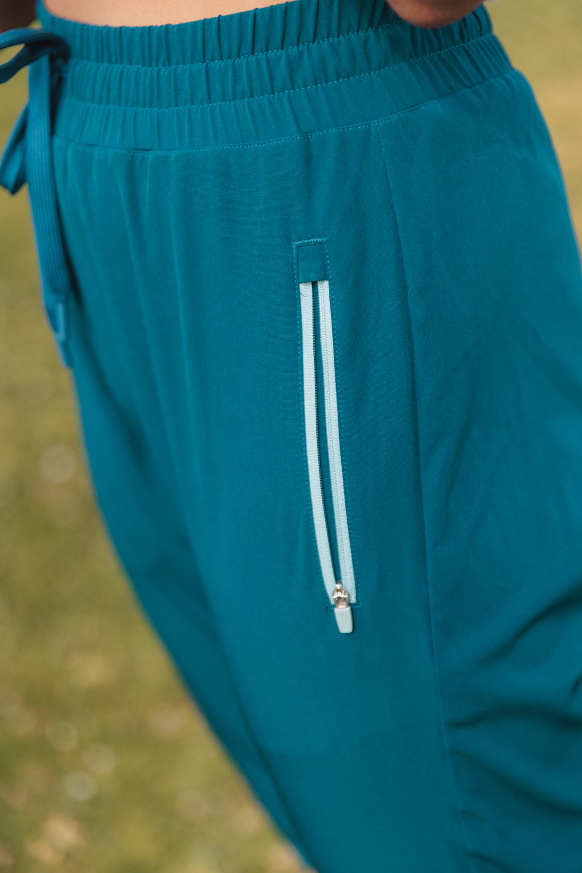 closeup of white outline of pocket on dark blue unisex rowing pant
