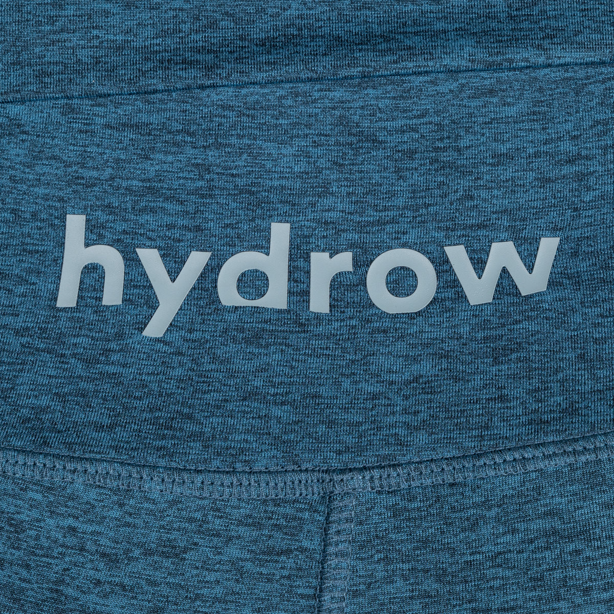 hydrow logo on dark blue heathered leggings