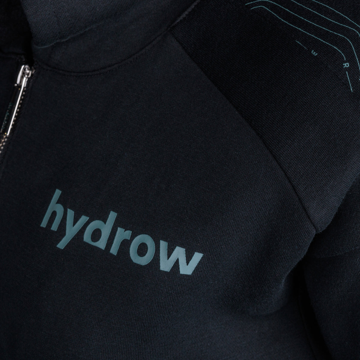 closeup of hydrow logo on left chest of 1/4 zip pullover hoodie