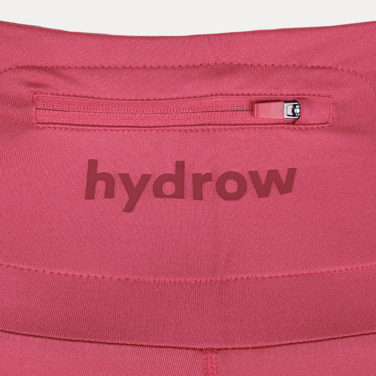 detail photo of rear zip[per pocket near waistband. hydrow logo shown.