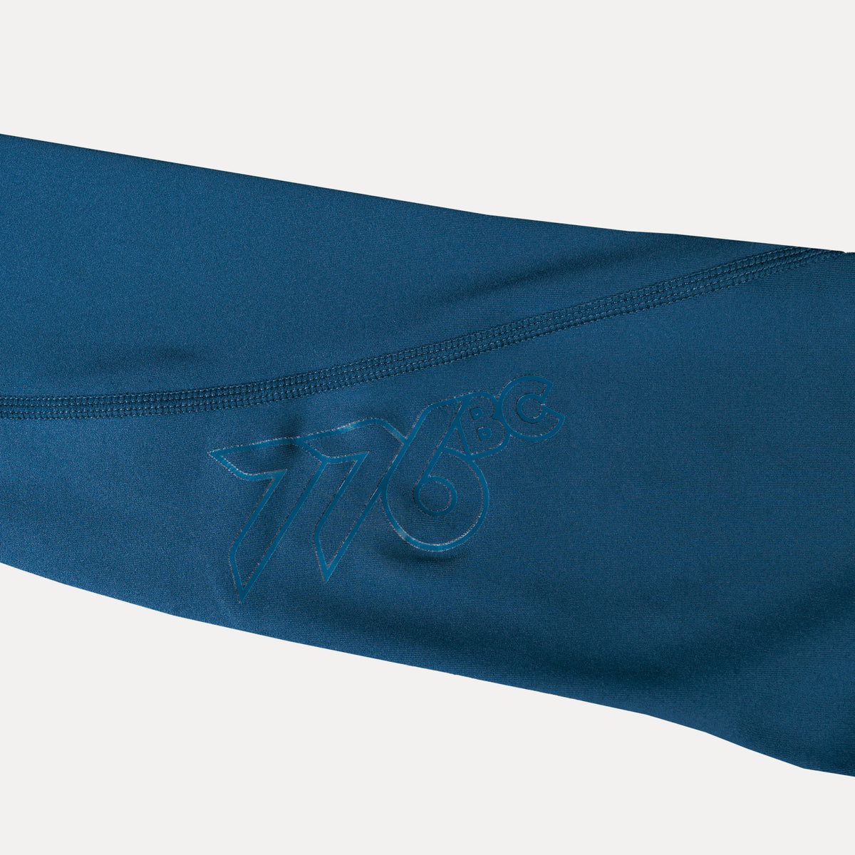 closeup of 776bc logo on leg of dark blue tights