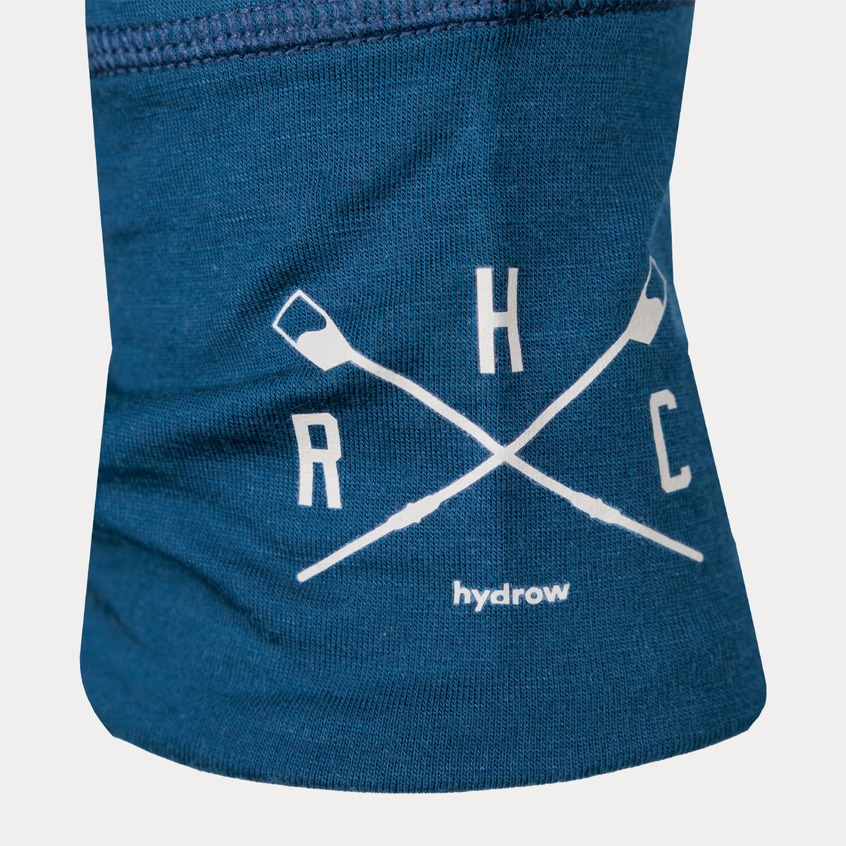 closeup of sleeve of quarterzip merino showing crossed oars hydrow logo