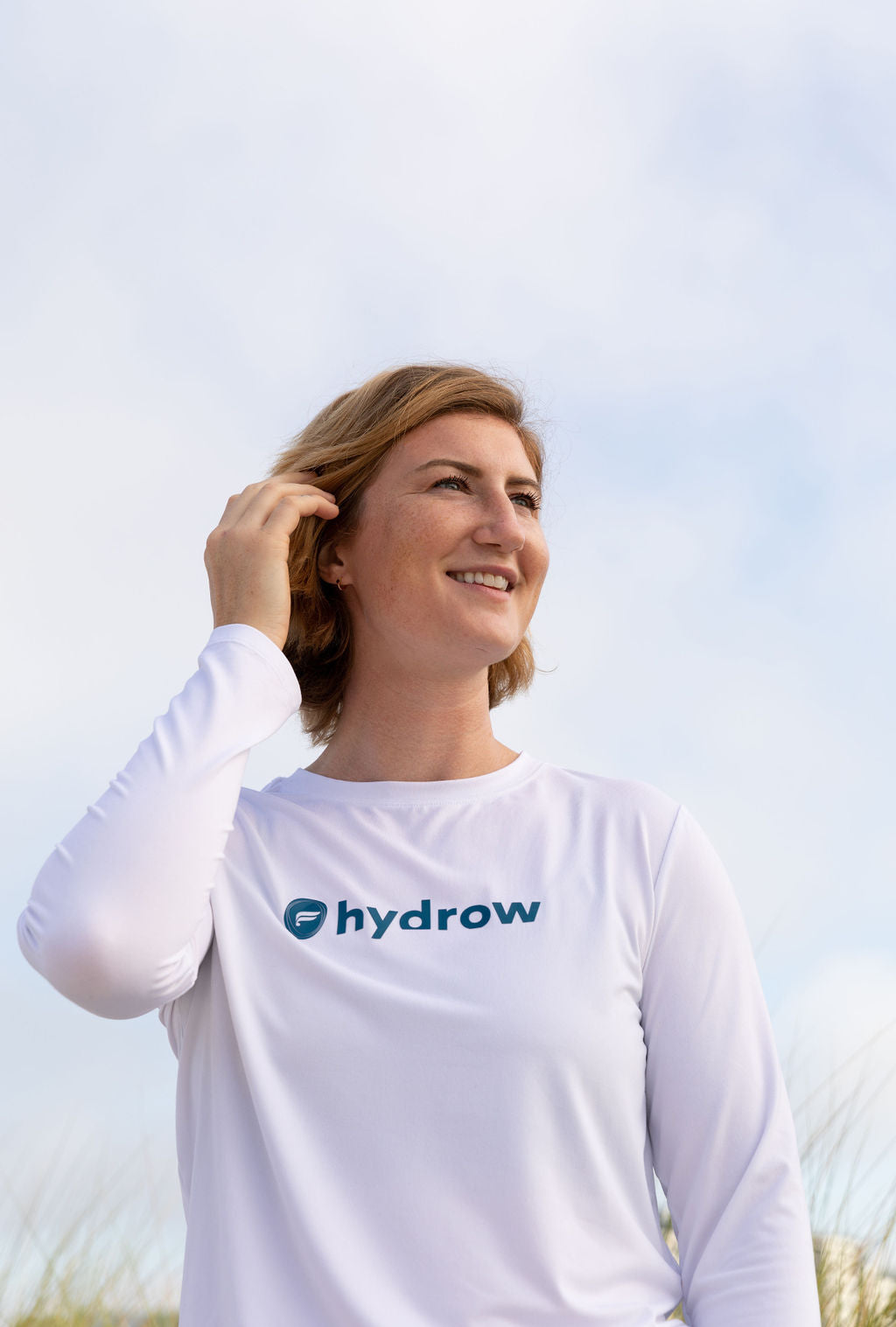 White long sleeve shirt with dark blue Fabletics and hydrow logo on front