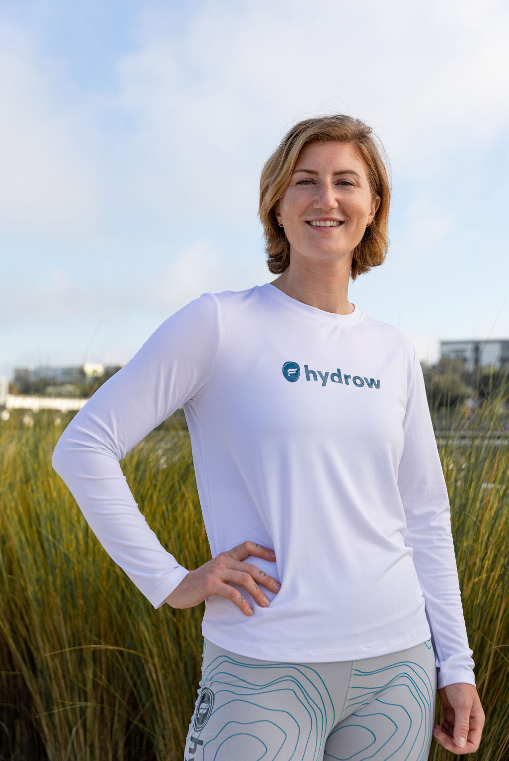 hydrow athlete wearing the dry-flex long-sleeve tee with hydrow fabletics logo on front