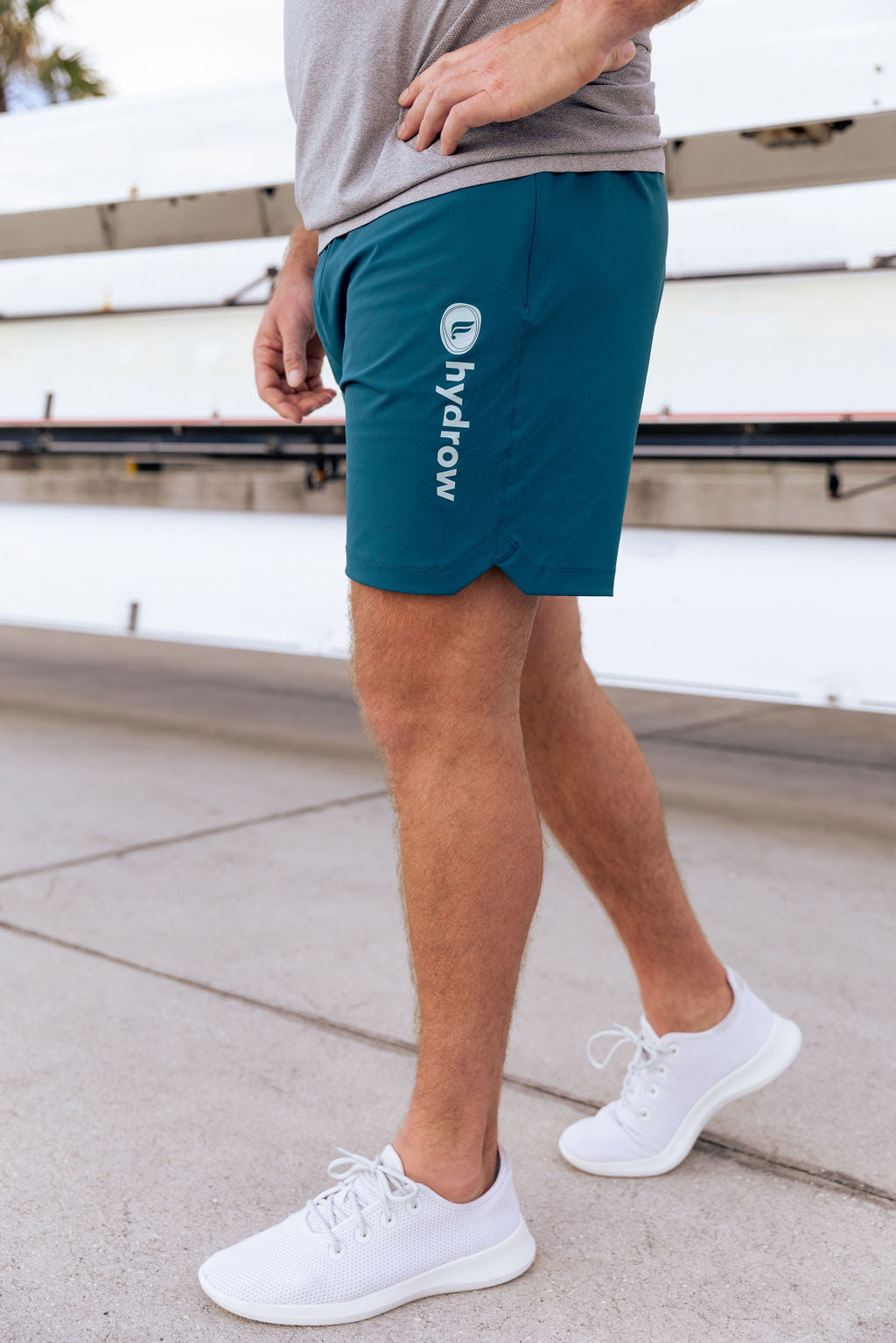 hydrow athlete wearing  the 7&quot; one short showing white hydrow fabletics logo on left thigh