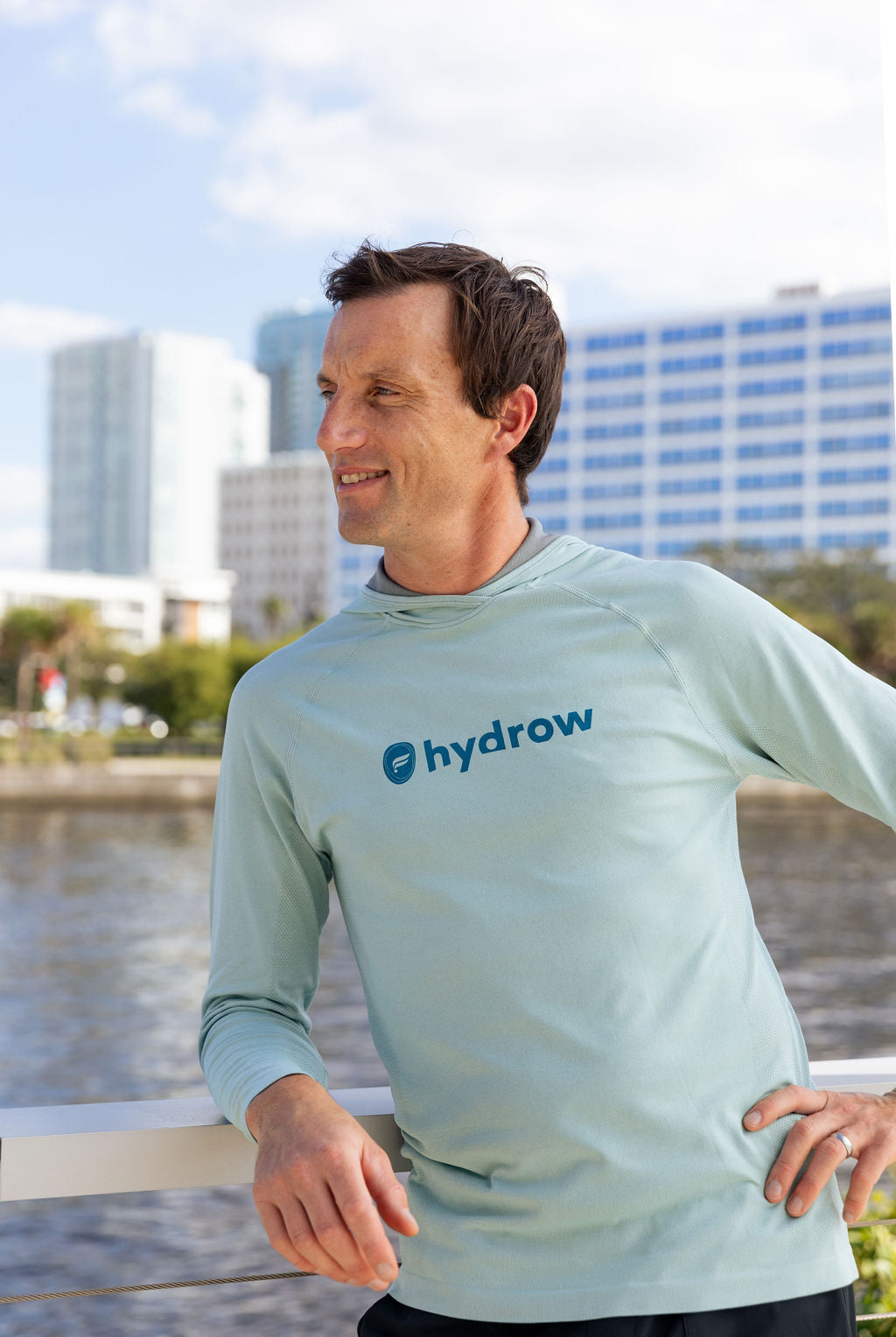 hydrow athlete posing in the training day hoodie with hydrow x fabletics logo on center chest