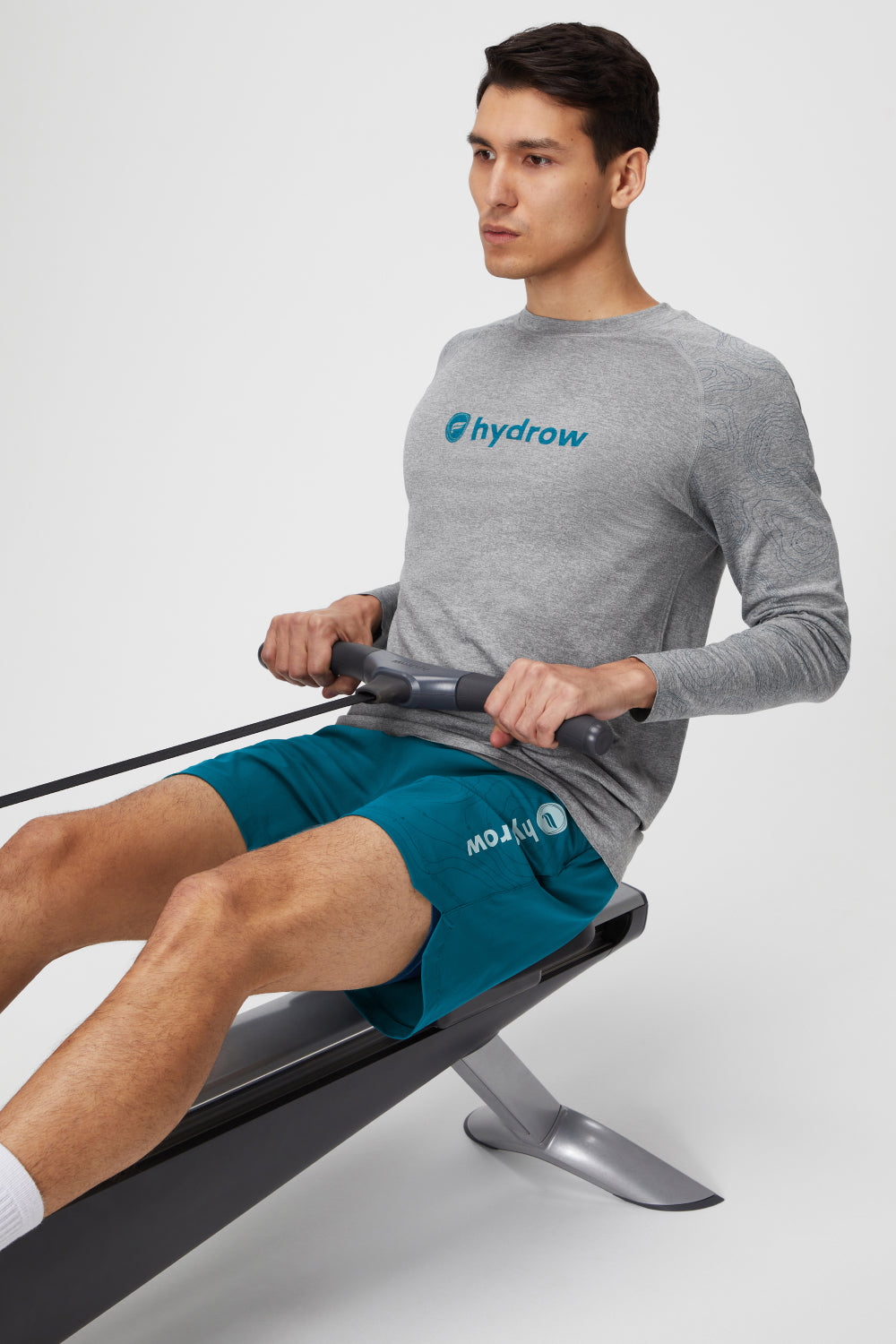 man using hydrow rower wearing the 7&quot; one short and the long sleeve training day tee