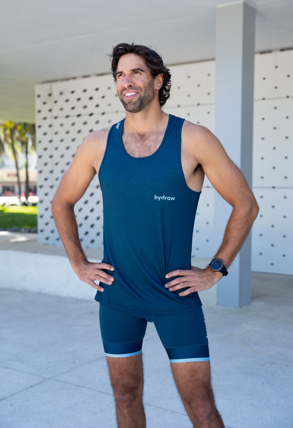 man in dark blue hydrow tank with light blue hydrow logo on lower left chest