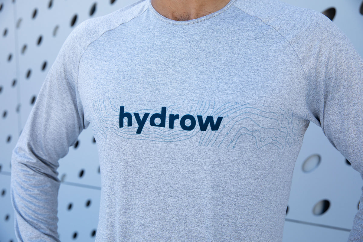 closeup of chest on grey ls shirt showing hydrow logo in dark blue and line graphic