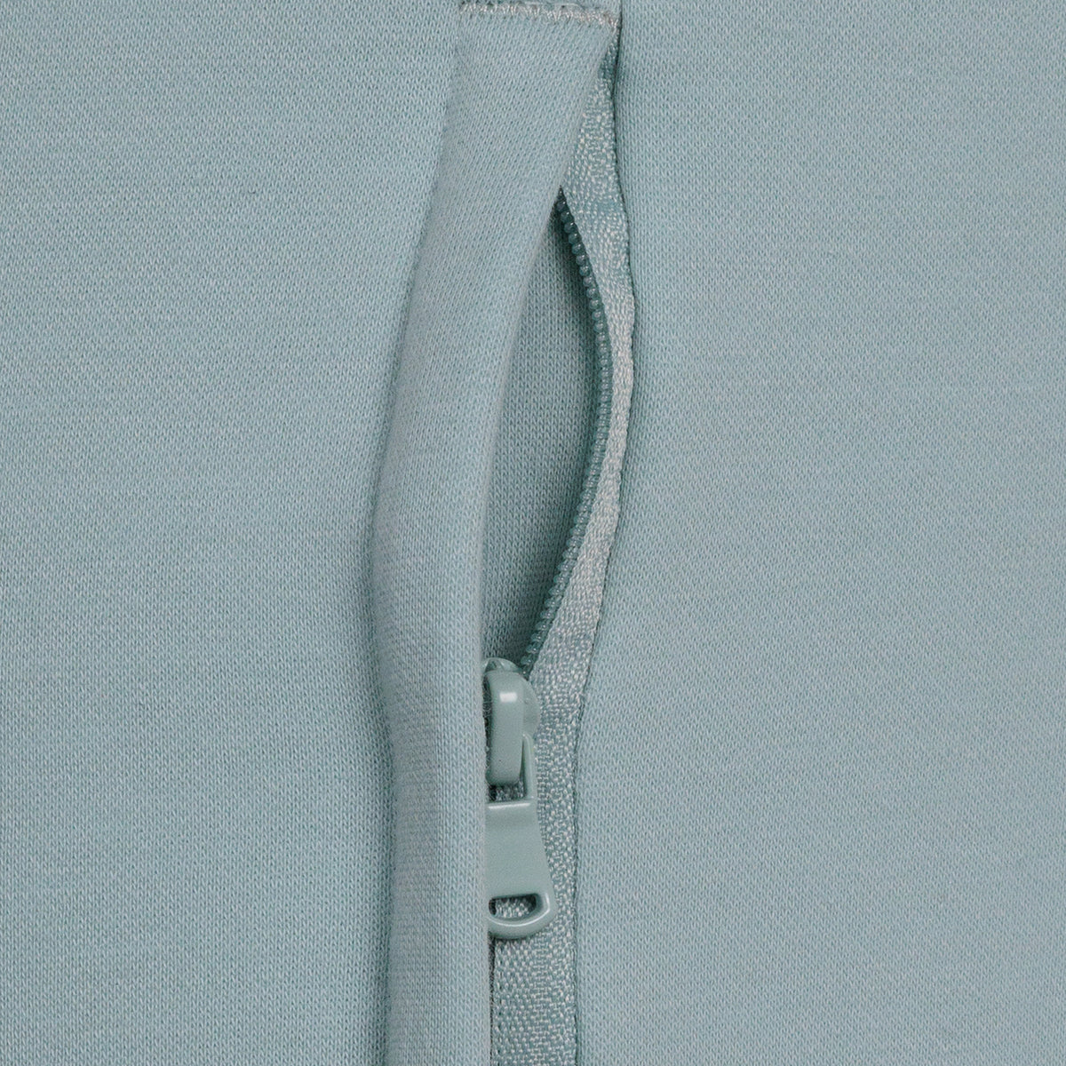 closeup of zip pocket on light blue jogger