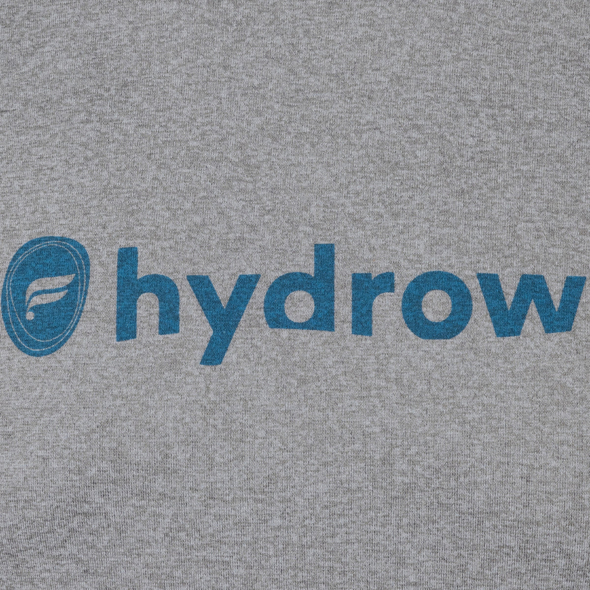 closeup of dark blue fabletics and hydrow logo on grey tshirt