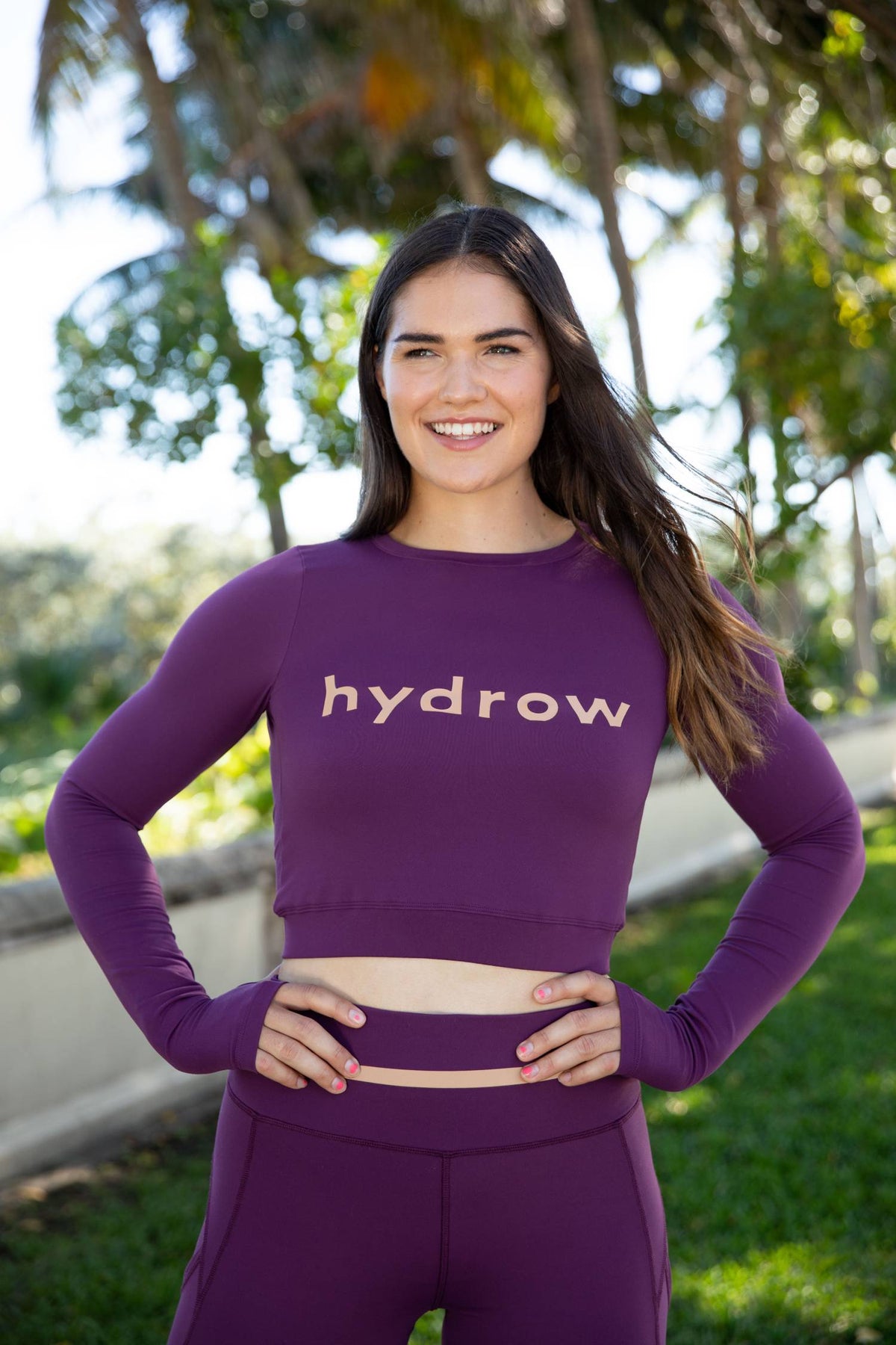 woman in plum keyhole crop with hydrow logo on chest